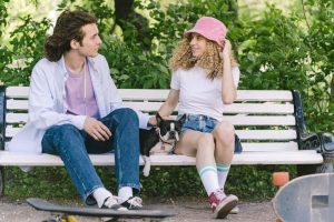man-and-woman-sitting-on-the-bench-with-dog